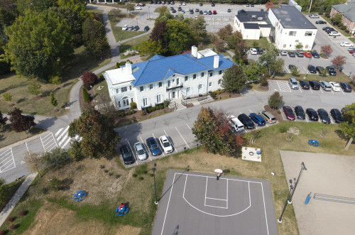 Aerial shot of the front of Rosary hall, part of the basketball and volleyball court are visible